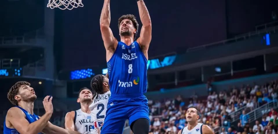 Player dunking during basketball game between Israel and Greece