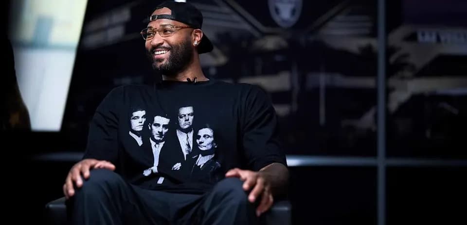 Player sitting in interview setting, wearing graphic t-shirt