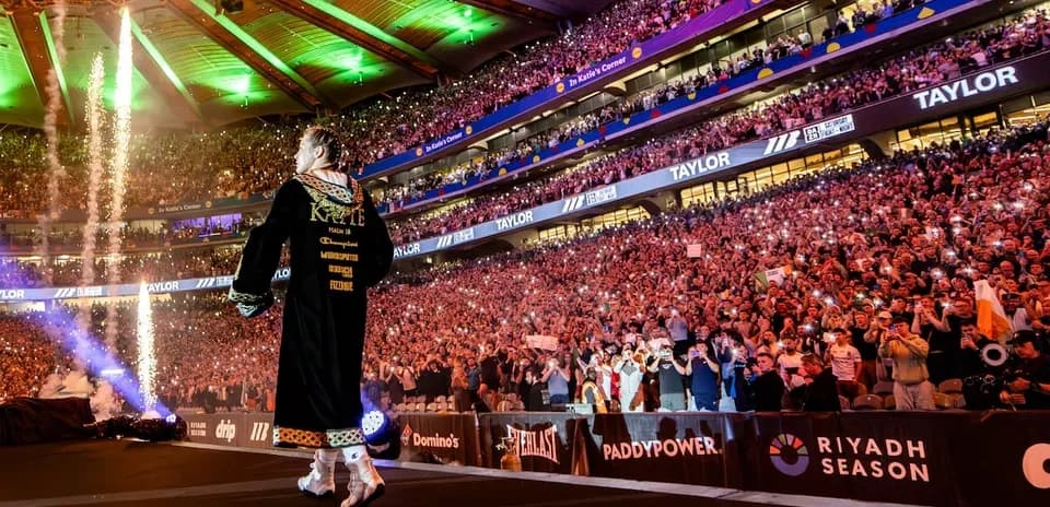Boxer entering arena with crowd cheering and fireworks