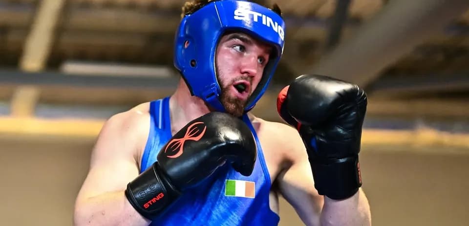 Boxer in blue gear preparing for a match