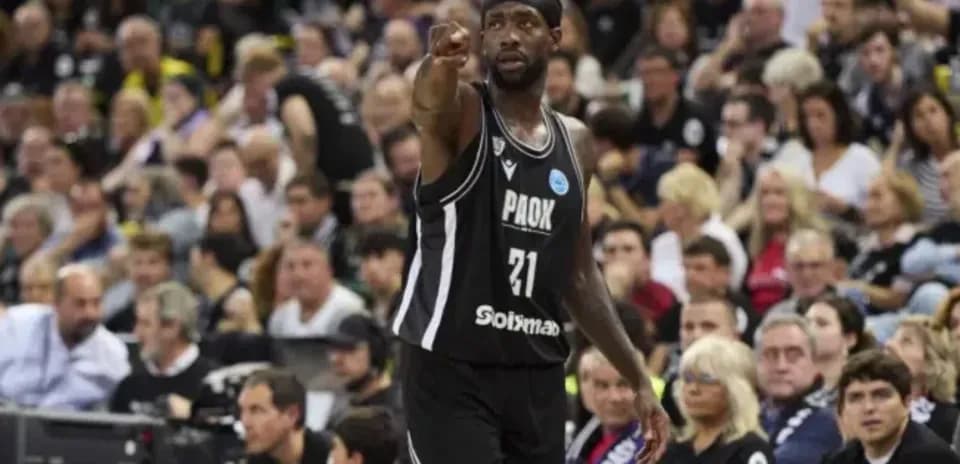Player in black jersey directing teammates during game