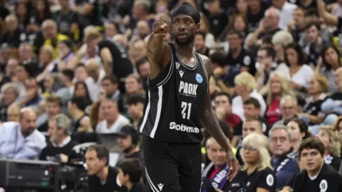 Player in black jersey directing teammates during game