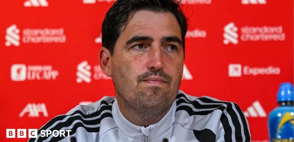 Manager at press conference with sponsor backdrop
