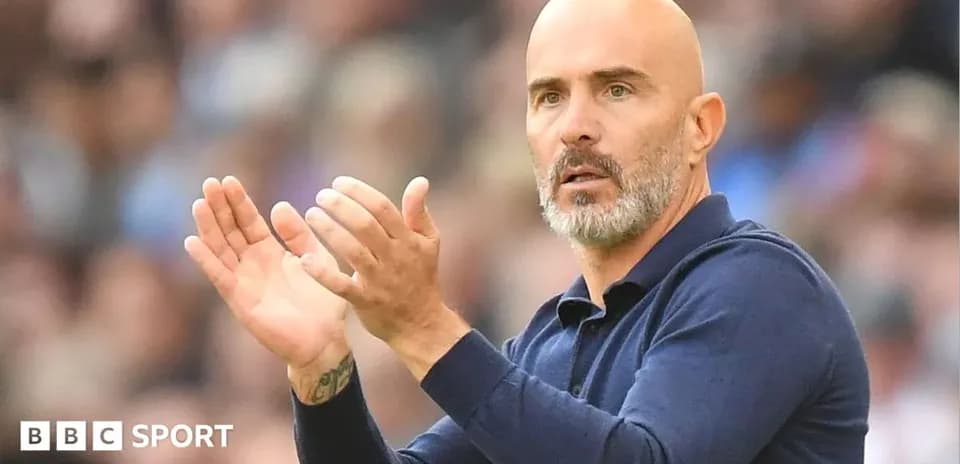 Coach clapping during a match on the sidelines