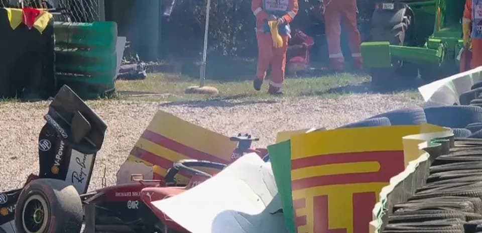 Damaged car near tire barriers at racetrack