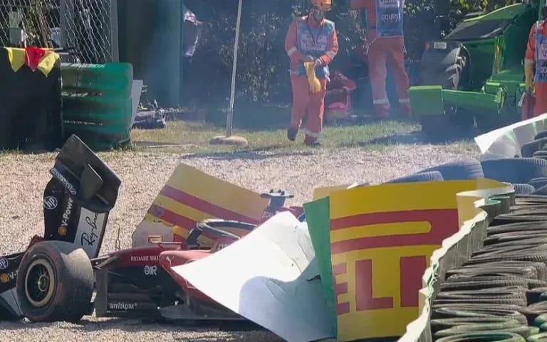 Damaged car near tire barriers at racetrack