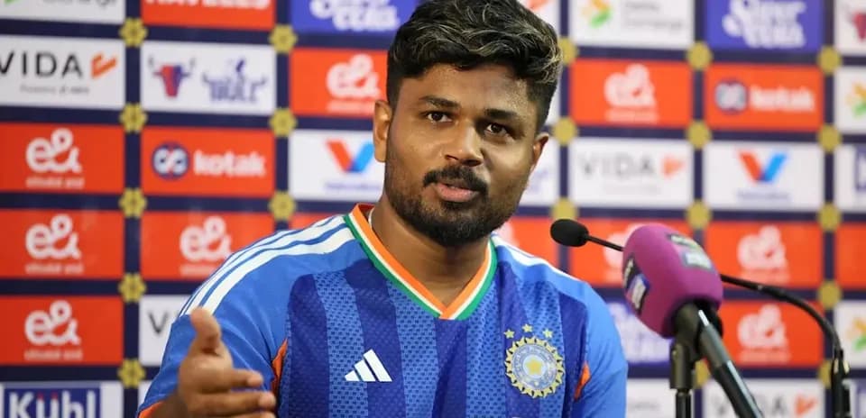 Cricketer speaking at press conference with microphone