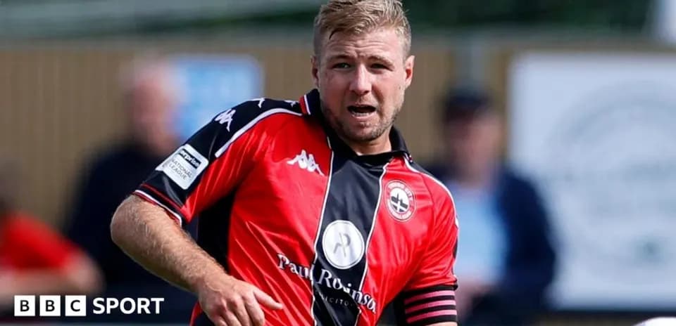 Player in red jersey running during a match