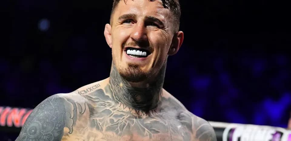 Smiling boxer with tattoos in the ring