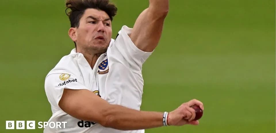 Cricketer bowling with ball in hand