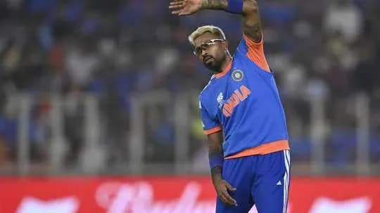 Cricketer waving to fans during match warm-up