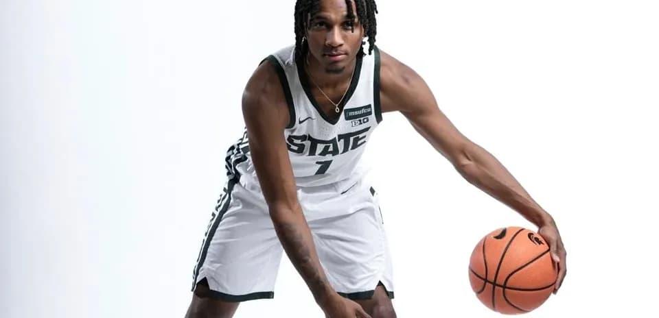 Basketball player dribbling ball in team uniform