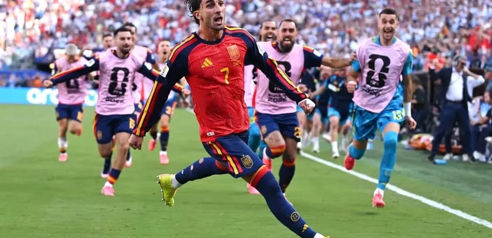 Spain player celebrating goal with teammates during match