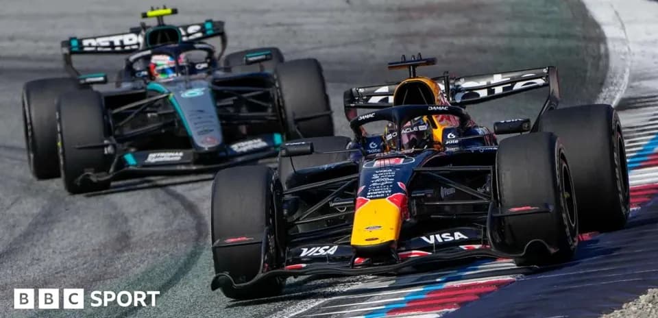 Two Formula 1 cars racing on track