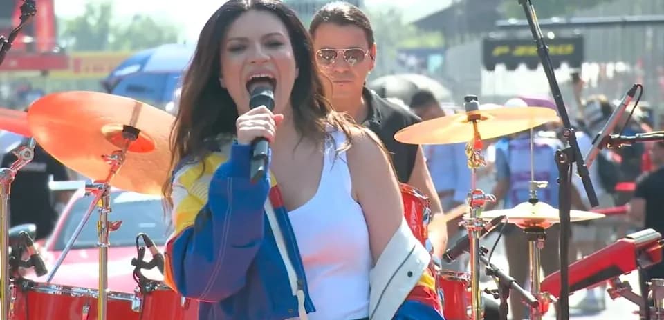 Singer performing on stage with band during event