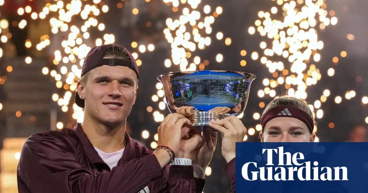 Two tennis players celebrating with trophy and fireworks