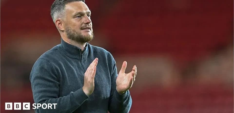 Manager applauding the crowd after the match