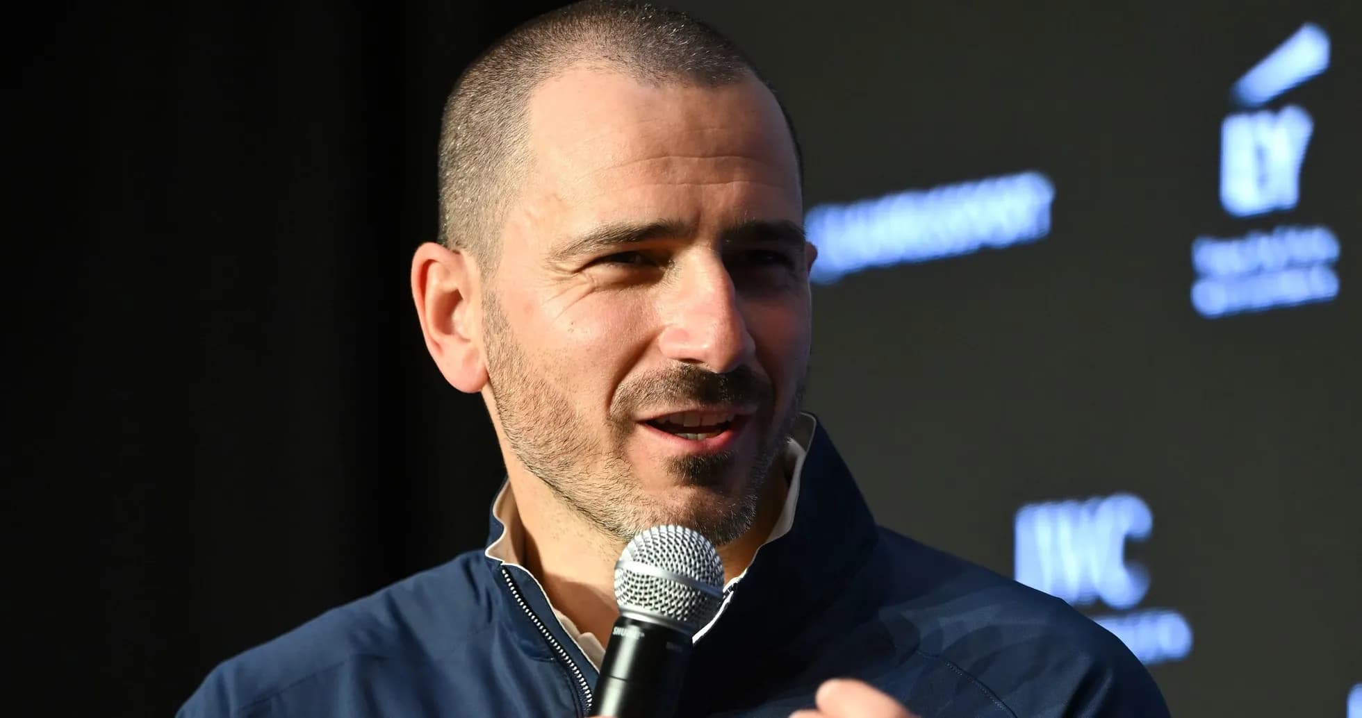 Speaker discussing at event with microphone in hand