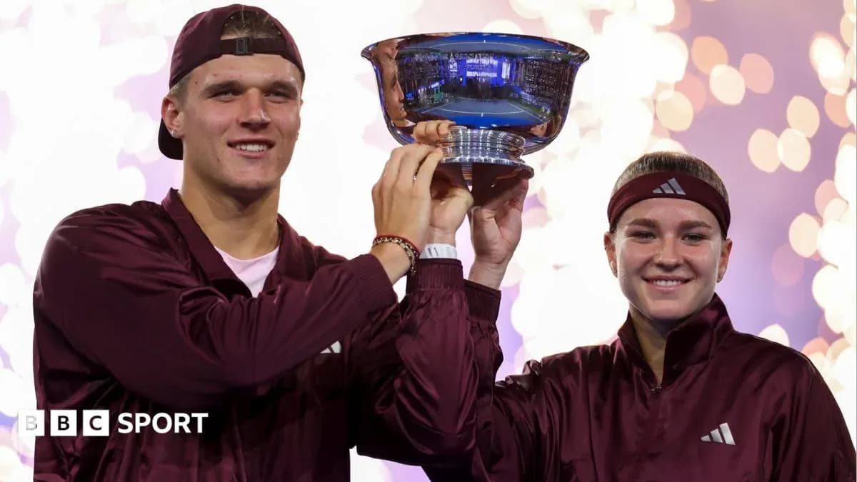 Players celebrating victory holding trophy together