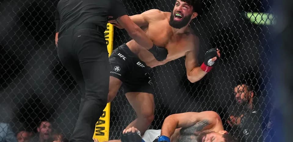 Fighter celebrating after winning match in octagon