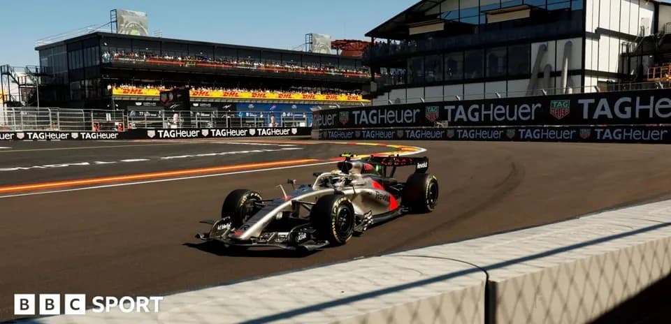 Formula 1 car racing at a circuit with grandstands