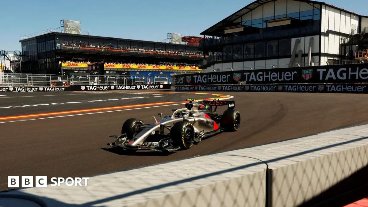 Formula 1 car racing at a circuit with grandstands