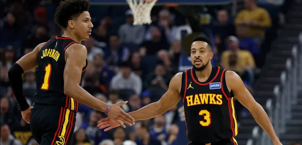 Two Atlanta Hawks players celebrating during a game