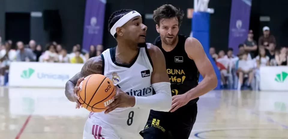 Player dribbling basketball with opponent chasing