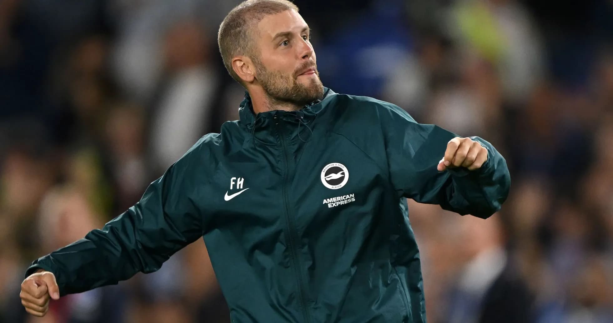 Man celebrating in Brighton kit on the sidelines