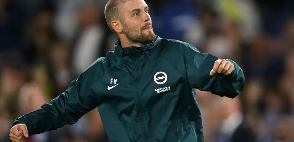 Man celebrating in Brighton kit on the sidelines