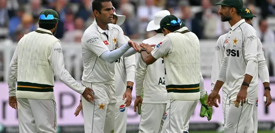 Pakistani cricket players celebrating a wicket on field