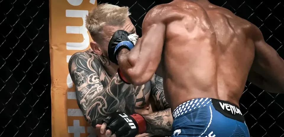 Two fighters exchanging blows in the octagon
