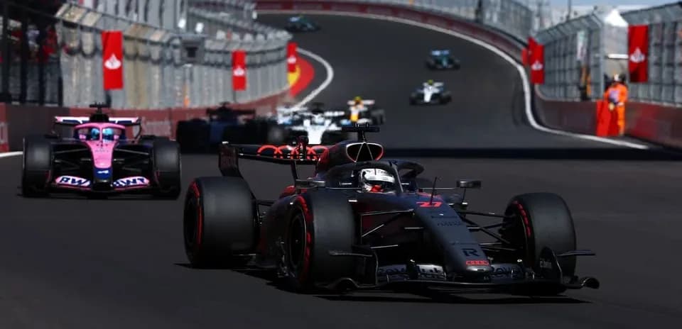Formula 1 cars racing on a circuit track