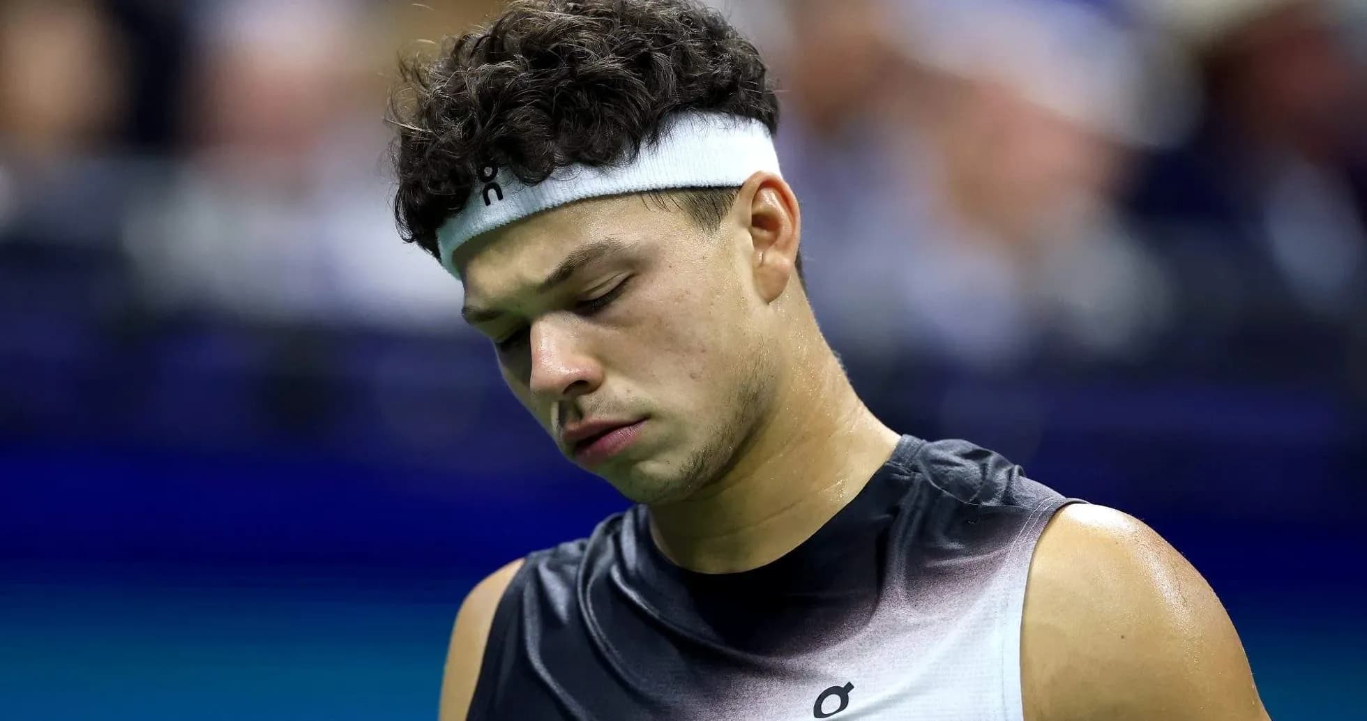 Tennis player looking down during a match