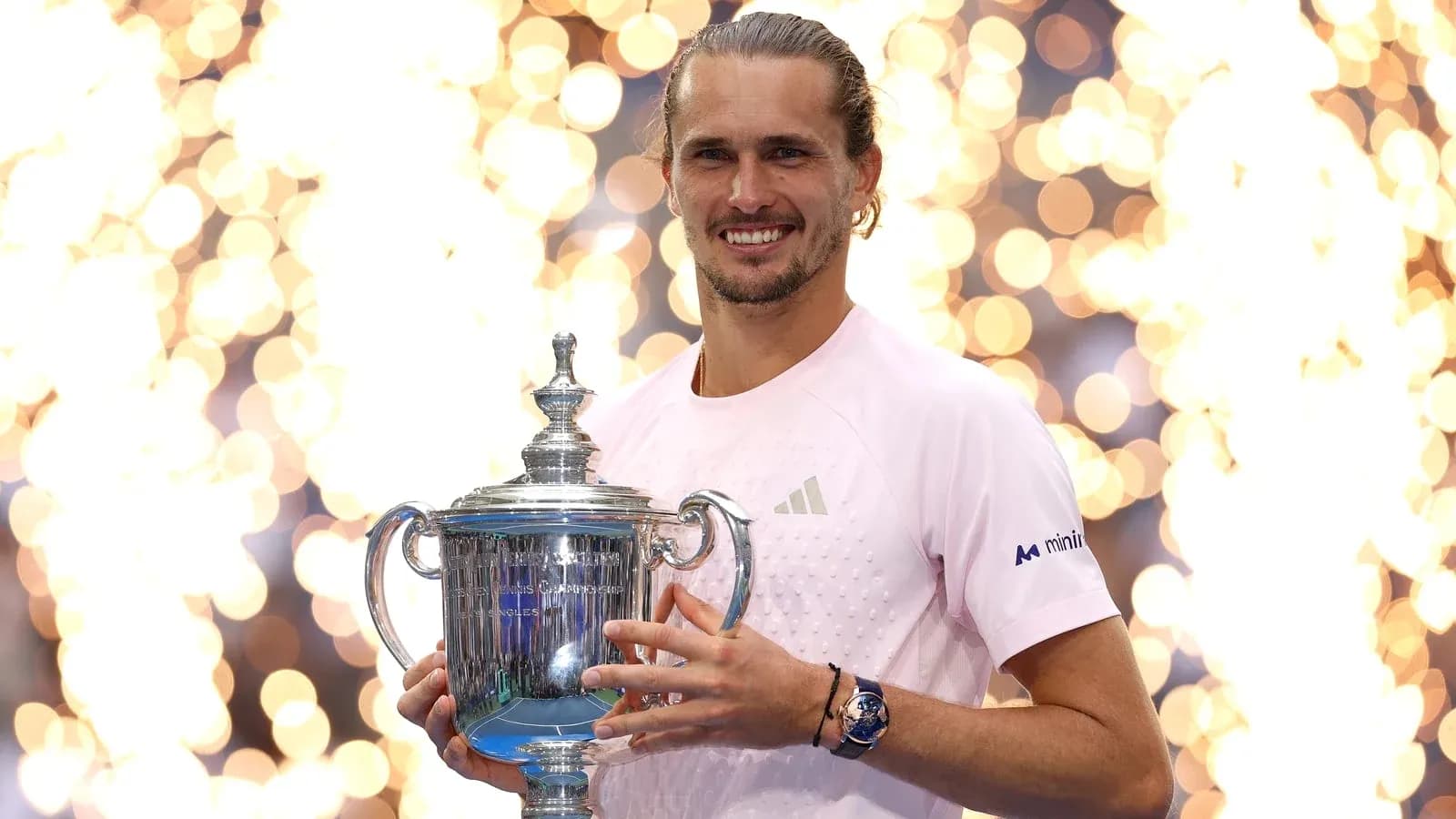 Player holding trophy with fireworks in background