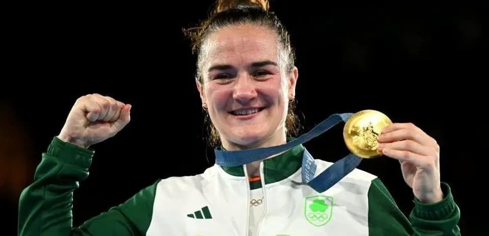 Athlete celebrating with gold medal and raised fist