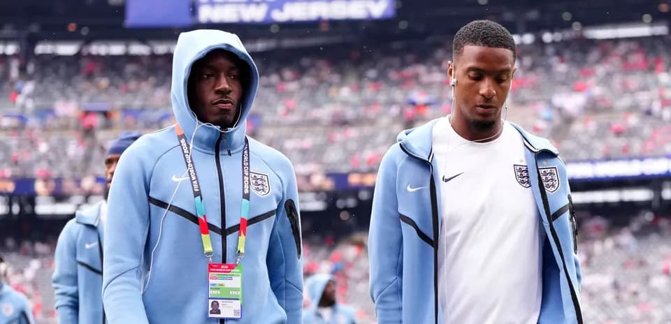 Two England players walking on stadium field