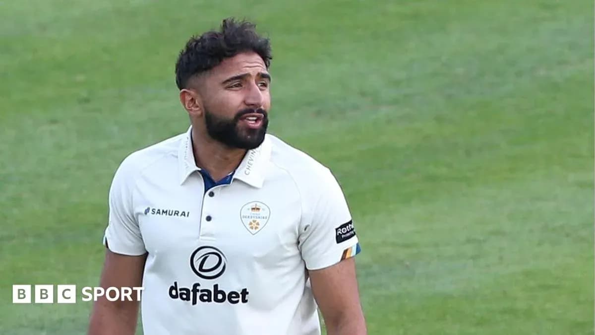 Cricketer in white uniform on the field