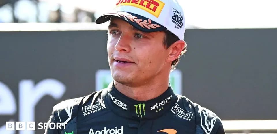 Racing driver in McLaren team uniform speaking