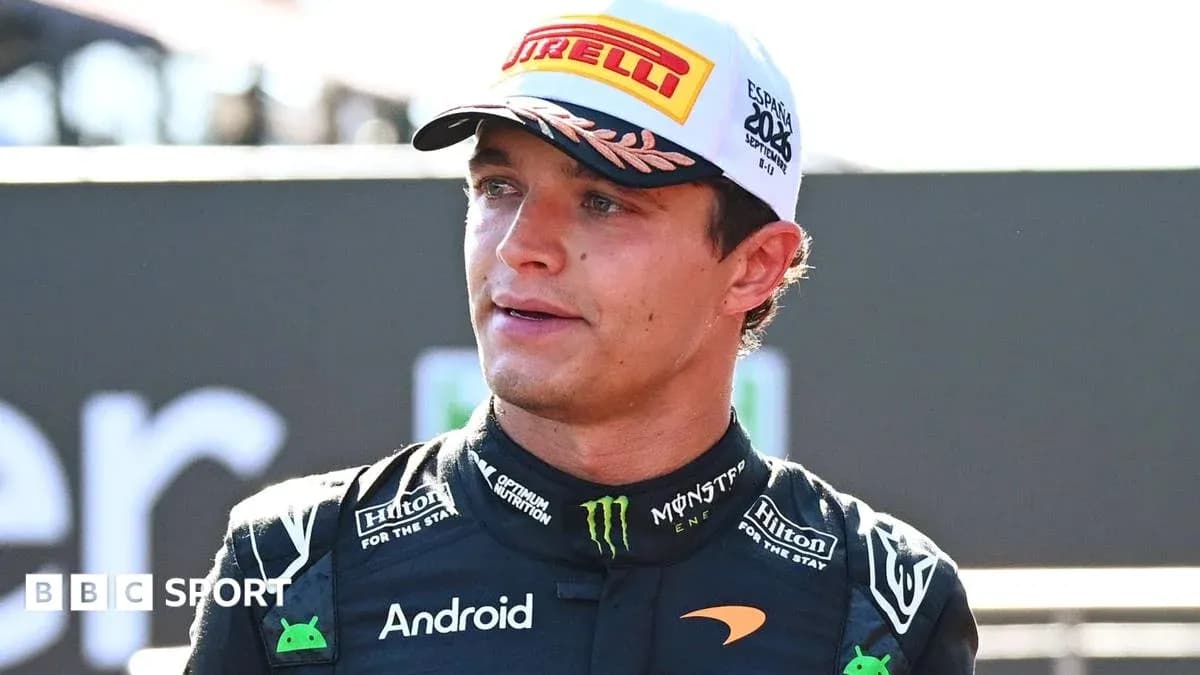 Racing driver in McLaren team uniform speaking