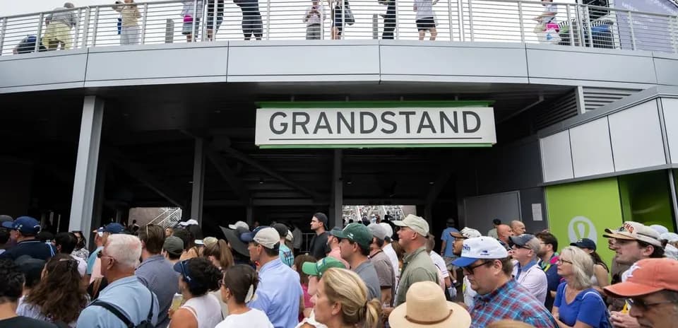 Crowd gathering at entrance to grandstand area
