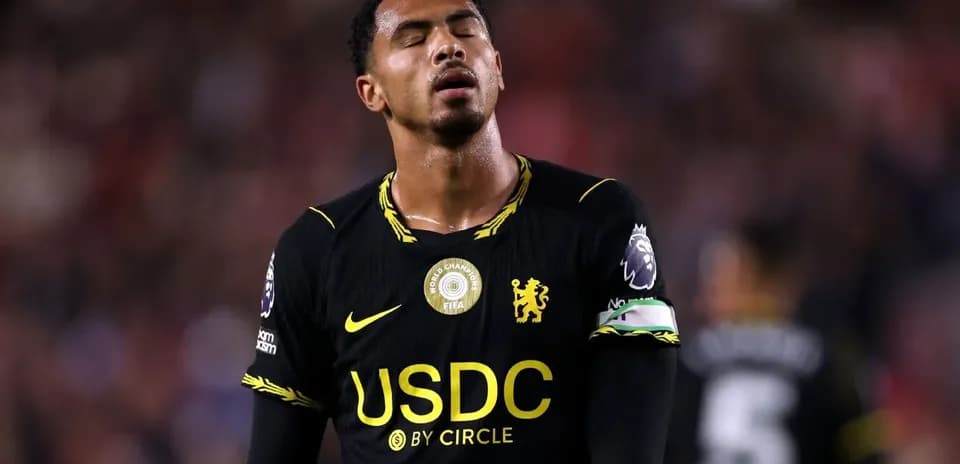 Player in black jersey looking frustrated on field
