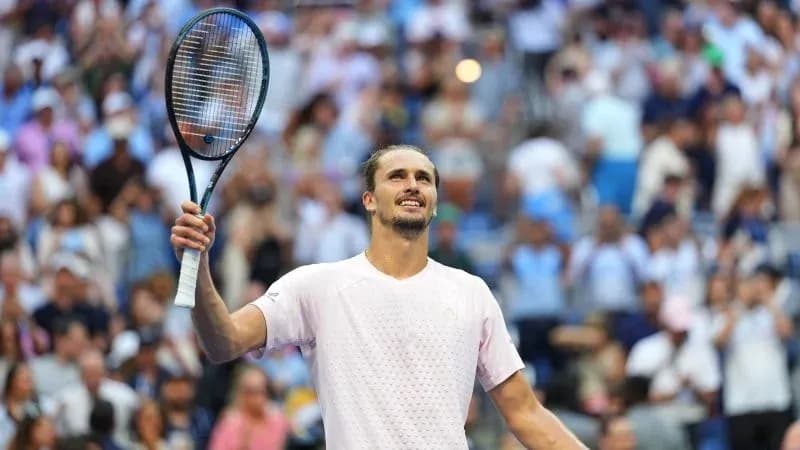 Player celebrating victory with raised racket in crowd
