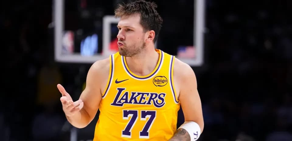 Player celebrating in yellow Lakers jersey during game
