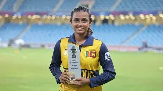 Cricketer holding Player of the Match trophy