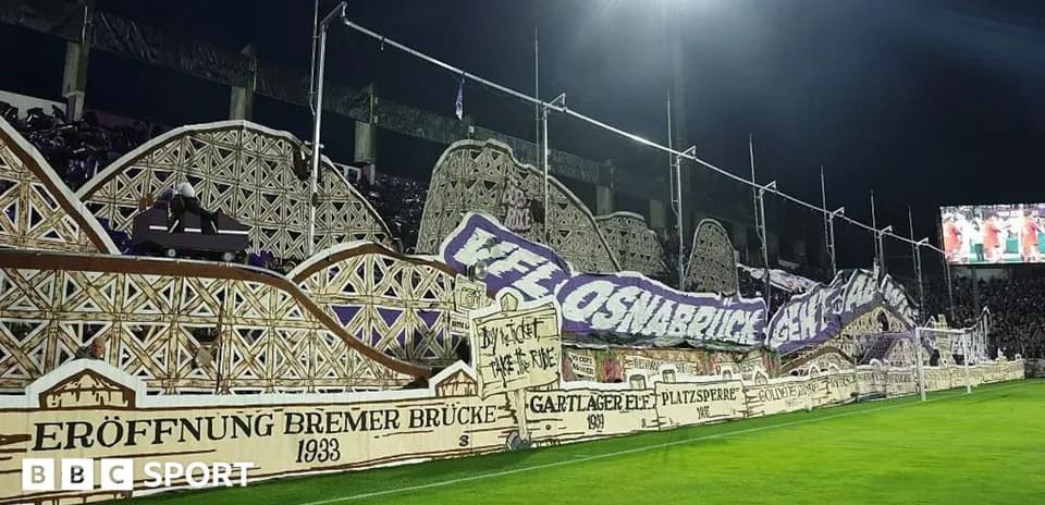 Fan banner display at stadium during night match
