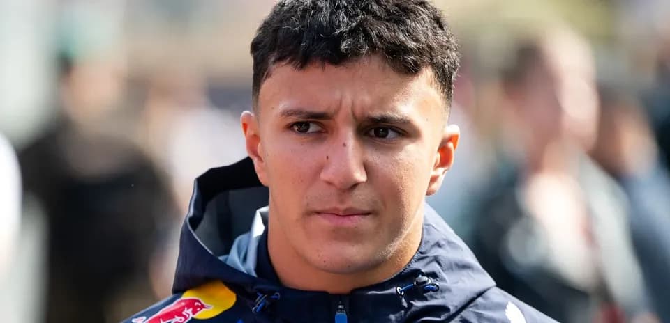 Driver wearing Red Bull Racing jacket in paddock