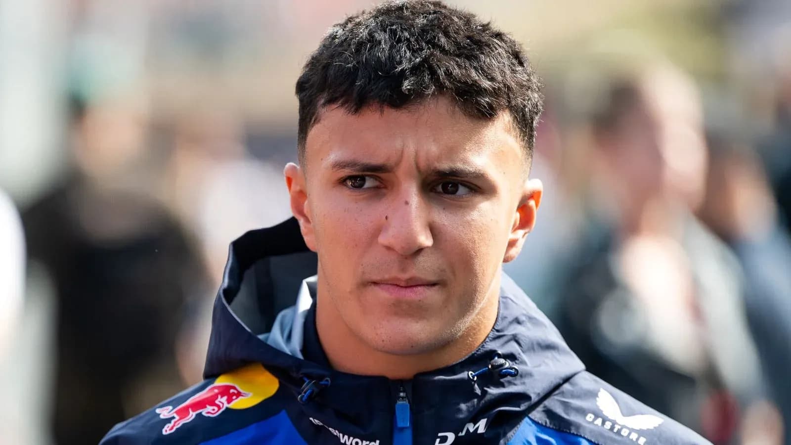 Driver wearing Red Bull Racing jacket in paddock