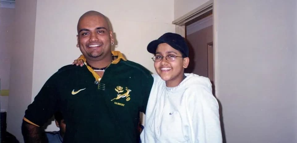 Two people smiling together in a room