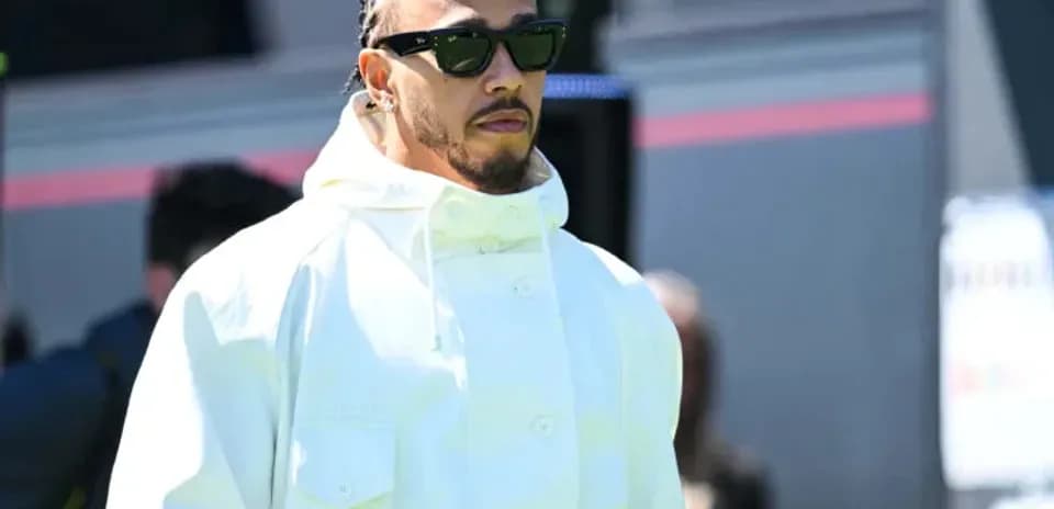 Man in white jacket and sunglasses walking